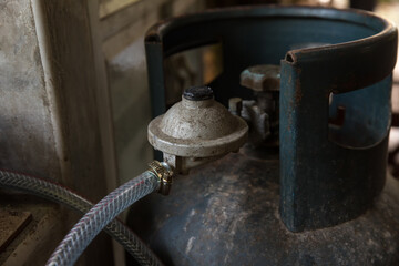 Rusty pressure regulator and operating valve of cooking gas tanks. LPG . Hose connect to the cylinder red gas supply. 