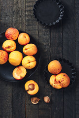 Ripe apricots on dark wood.
