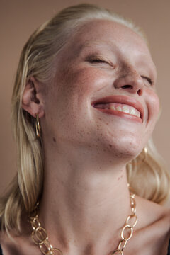 Young model wearing jewelry smiling 