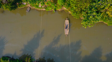 Aerial view of Boat sledding to cross the river. Bekasi, Indonesia, July 9, 2021