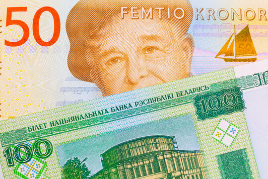 A macro image of a gray and orange fifty kronor note from Sweden paired up with a green one hundred ruble note from Belarus.  Shot close up in macro.