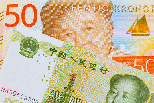 A macro image of a gray and orange fifty kronor note from Sweden paired up with a green and white one yuan note from China.  Shot close up in macro.