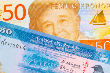 A macro image of a gray and orange fifty kronor note from Sweden paired up with a blue and white fifty rupee bank note from Sri Lanka.  Shot close up in macro.