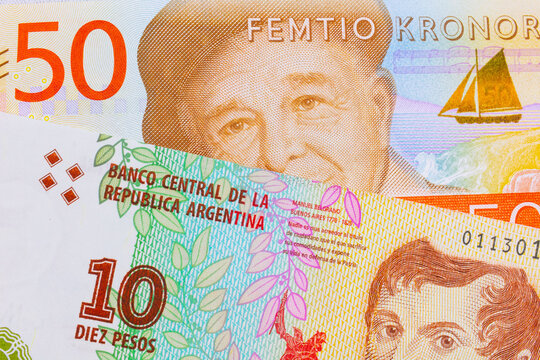 A macro image of a gray and orange fifty kronor note from Sweden paired up with a colorful ten peso note from Argentina.  Shot close up in macro.