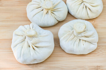 Uncooked dumplings or khinkali stuffed with meat  ready for boiling.