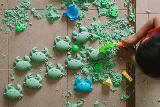 Asian boy playing kinetic sand