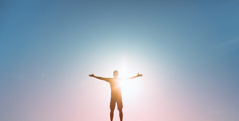 People happiness, hope, light , and power concept. Man with arms raised to the colorful sky  - obrazy, fototapety, plakaty