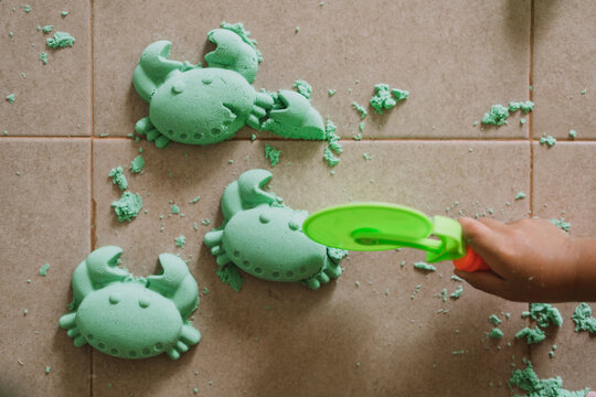 Asian boy playing kinetic sand