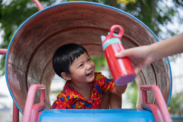 Asian boy playing in outdoor playground