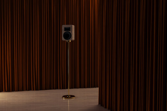 Isolated speaker in an interior between curtains