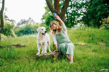 A girl takes a selfie with her dog

