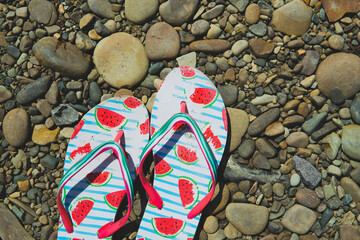 slippers flip flops on a stone beach