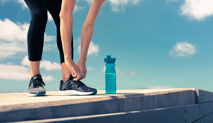 Get fit drink water and stay hydrated concept. Female runner next to bottle of water.  - obrazy, fototapety, plakaty