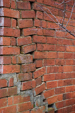Broken and crooked brick wall