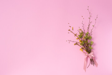 Spring bouquet from twigs with first leaves and flowers. Copy space.