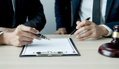 Fototapeta premium Lawyer hand holding pen and providing legal consult business dispute to the man