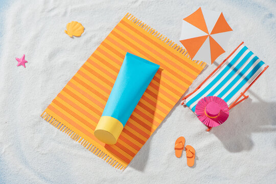 sunscreen products lying on papercut beach, skincare ads in top view angle