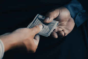 Back side of businessman who give bribe to the Government officials, the concept of corruption and...