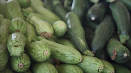 Zucchini at market. Raw ripe squashes. Courgettes