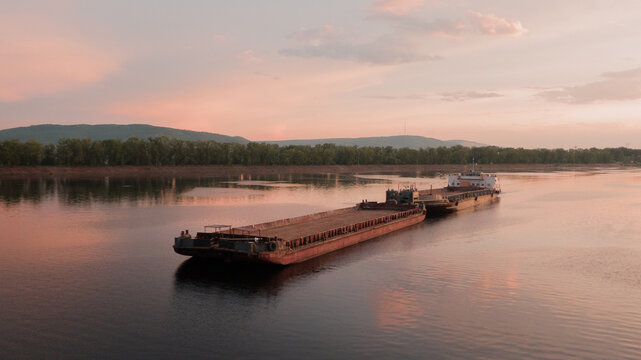 Tugboat pushing the barge ship