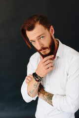 Studio photo of a beautiful young man with a beard