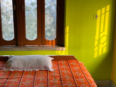 Home with pillow and bed with sun-rays on the wall