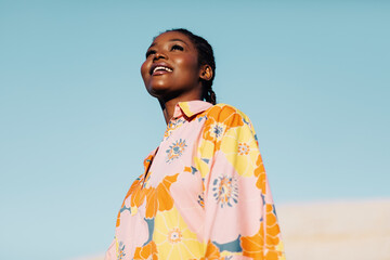 Carefree black woman in fashionable summer outfit
