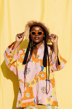 Trendy black woman in colorful summer outfit

