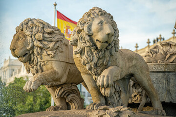 Statue of the goddess Cibeles and the lions in the city of Madrid, Spain, during a sunny summer day with few clouds 