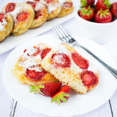 Homemade pancakes with yogurt and strawberries.