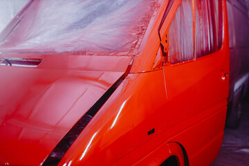 car body repair, painting a truck in red.