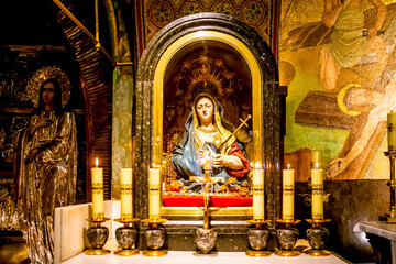 Fototapeta na wymiar Jerusalem, Israel - 23 June 2021: small altar the Mater Dolorosa, Our Lady of Suffering. Crafted in the 1500’s, beautiful painted wooden statue was presented to church by Maria I of Portugal in 1778.