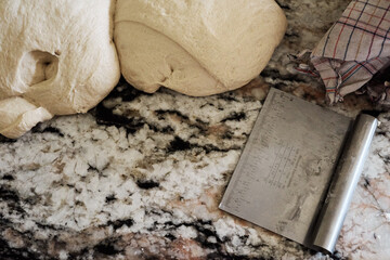 Dough and scraper placed on marble table
