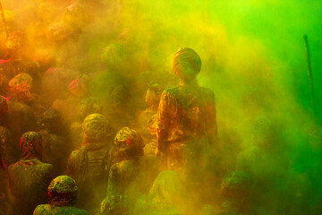 Indian People gathered in a temple,playing color powder