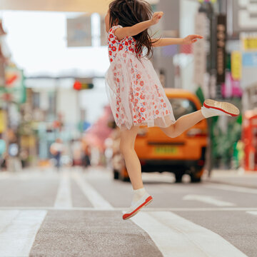 Little girl walk on zebra crossing in city street