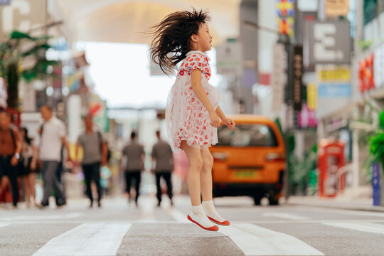 Little girl walk on zebra crossing in city street