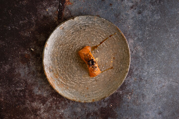 Top view of Ddelicious salmon nigiri on a rustic dish