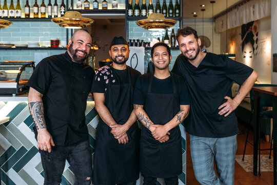Team of cooks and waiters of a small restaurant