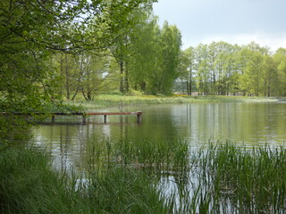 Fototapeta na wymiar Spring landscape with wooden pier, Schodno lake, Kashubian Lake District, Poland