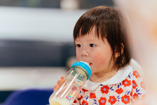 little girl with milk bottle 