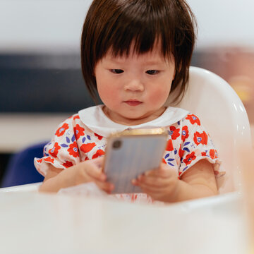 Cute little girl using cell phone