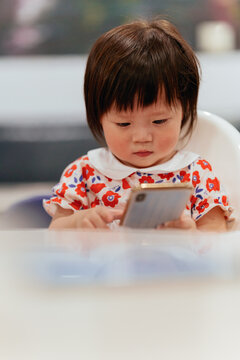 Cute little girl using cell phone