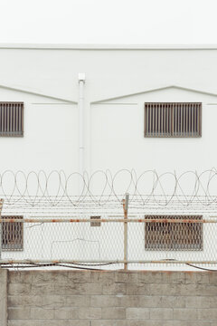 Close-up of a building wall surrounded by barbed wire