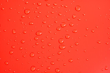 Rain drops on a red car bonnet