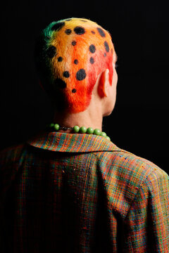 Anonymous alternative woman with rainbow hairstyle in studio