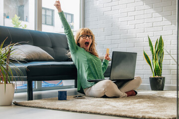 woman excited with joy at home buying online