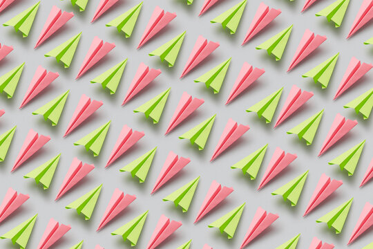 Pattern of green and pink origami paperplanes