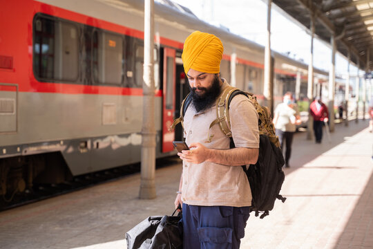 Commuter With Turban Using Smartphone