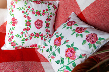 Decorative pillow with embroidery in the form of roses.
