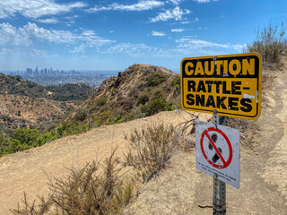 Caution Rattlesnake Sign in the Hollywood Hills with Los Angeles in the Background